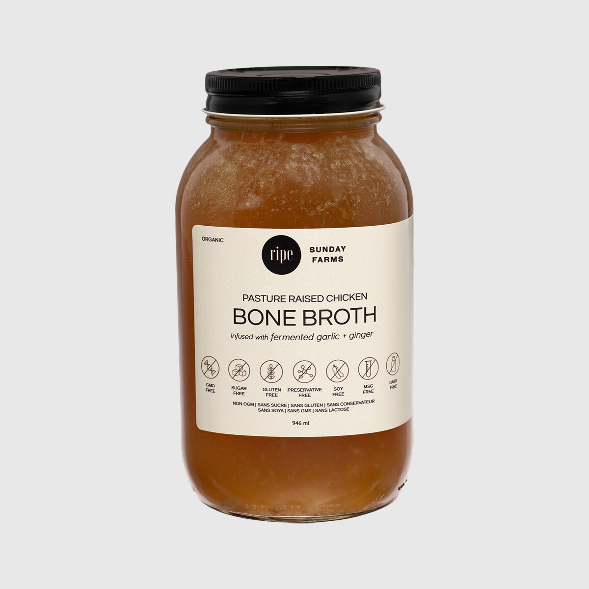 Ginger and lemon chicken bone broth in a glass jar