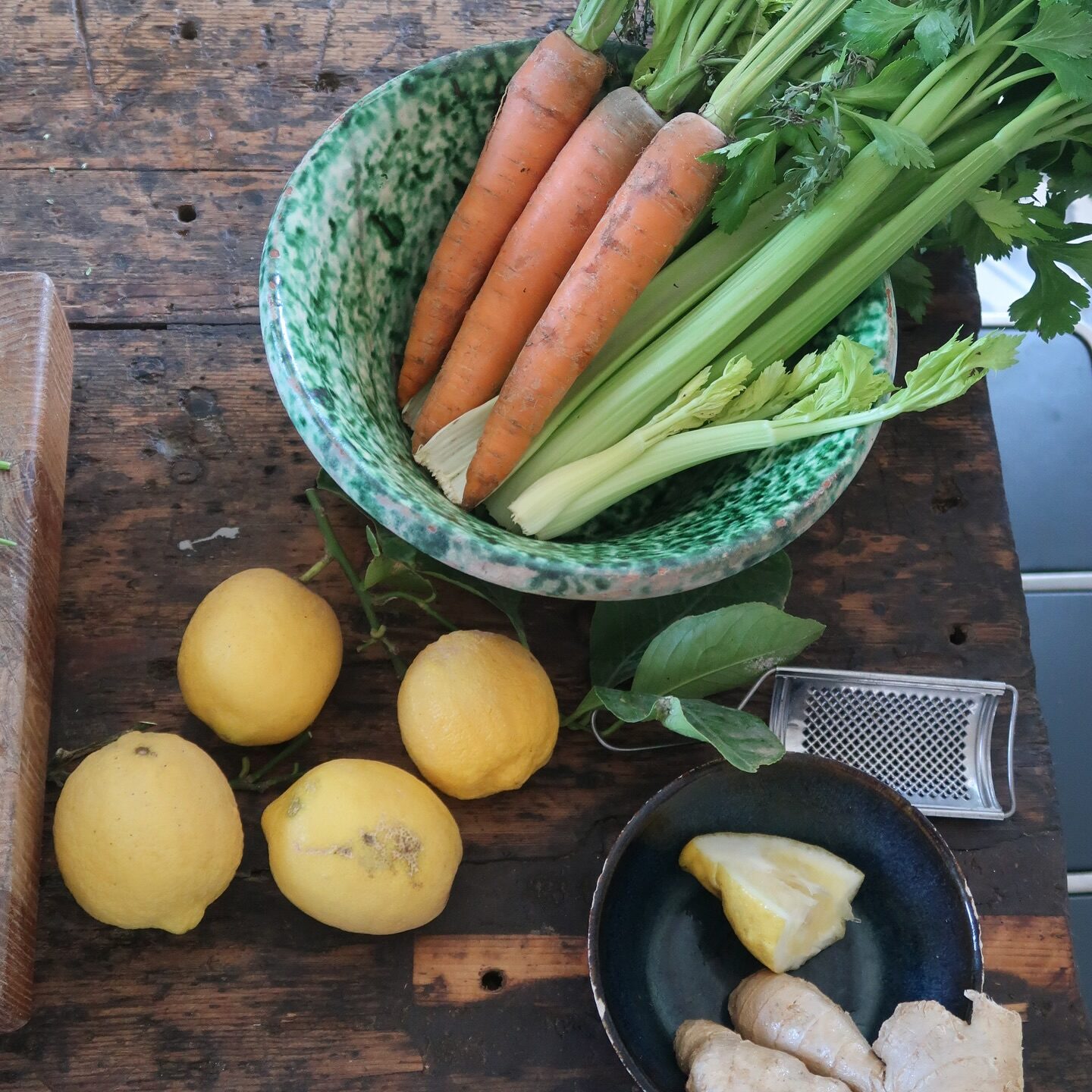 Fresh lemons, ginger root, carrots and celery on wooden table