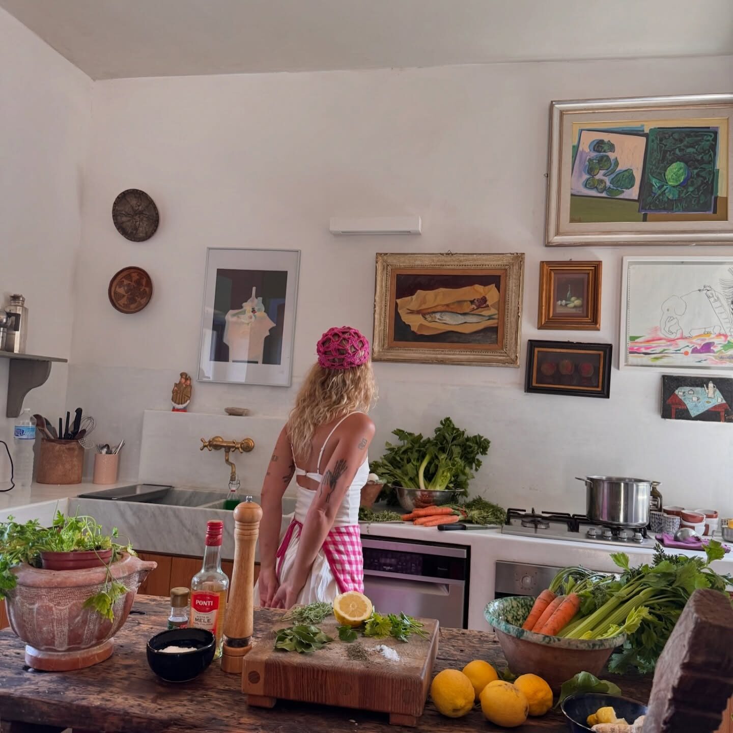 Mediterranean kitchen with stock pot, fresh celery and carrots ready for risotto