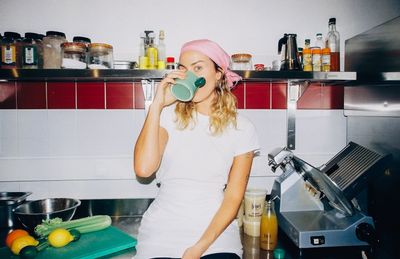 Sinead McInerney drinking a mug of Liquid Gold bone broth in the RIPE Lisbon kitchen