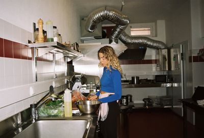Sinead McInerney prepping the herb base at the sink, RIPE Lisbon kitchen