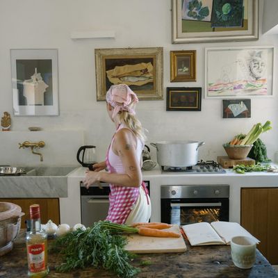 RIPE Europe founder, Sinead McInerney in a Mediterranean kitchen at Parco dei Sesi: stockpot on the stove, fresh produce, art on the walls